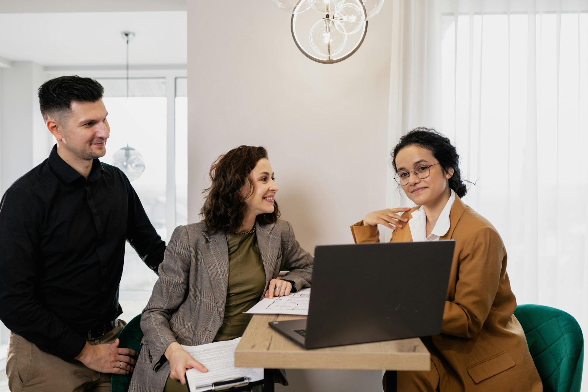 Professional business meeting with real estate consultant and couple in an office setting.